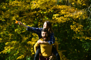 Girl and bearded guy or lovers have fun outdoors