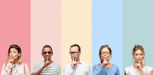 Mixed group of people, women and men with index finger on lips, ask to be quiet. Silence and secret...