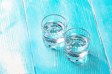 two glasses under the alcohol in the middle of the frame