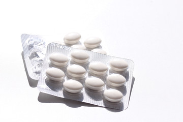 Fototapeta na wymiar Two blisters with white tablets. Medical drugs isolated on white. 