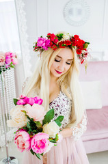 Portrait of a beautiful blond woman in a flower wreath