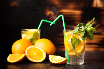 Delicous healthy orangeade on wooden background in studio photo