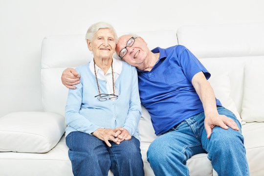 Glückliches Senioren Paar sitzt auf dem Sofa
