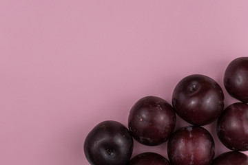 Plums on a pink background
