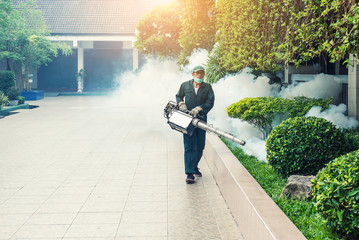 Naklejka premium Man work fogging to eliminate mosquito for preventing spread dengue fever and zika virus