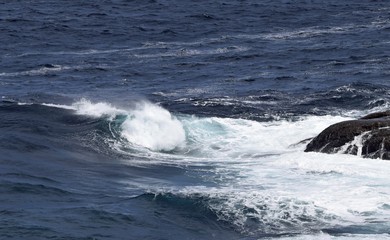 rolling wave hitting the rugged shoreline, Newfoundland Canada
