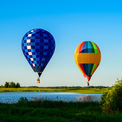 Bright colorful hot air balloons flying over lake in the clear b © smspsy