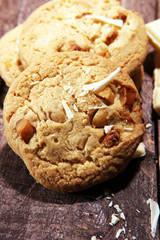 stack of macadamia nut and white chocolate cookies on table with chocolate chip