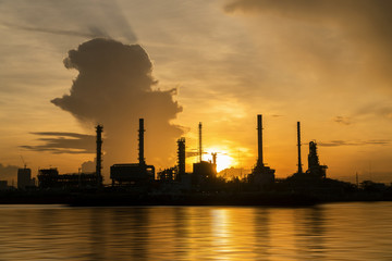 Fototapeta na wymiar Silhouette oil refinery and Petrochemical plant at dusk at sunrise