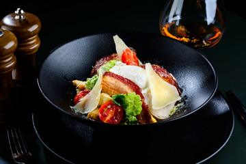 Delicious Ceasar salad with tomatoes bacon and poached egg