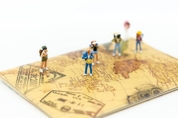 Miniature people : Backpacker group walking on passport. Image use for travel, business concept.