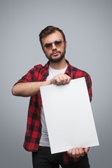 Cool guy showing blank paper