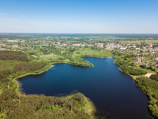 Fototapeta na wymiar Beautiful aerial view of blue lake and green forest district in 