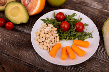 Healthy products. Close up of colorful fresh products placing on plate which standing on surface