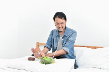 Healthy eating concept. Asian men are choosing to eat with their hands. Asian men want to eat healthy food