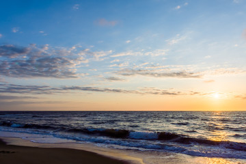 Fototapeta na wymiar Beach sunrise or sunset with cloudy sky