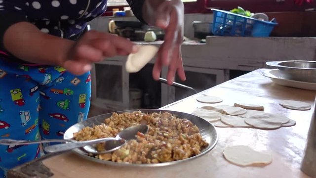 Nepali women prepare homemade Momo dumplings food in kitchen for tourist at Nepal.