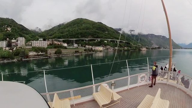 Tourist ship sails along the Lake Geneva to the Chillon Castle.