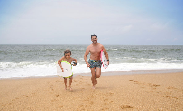 Father and son at the beach with bodyboard