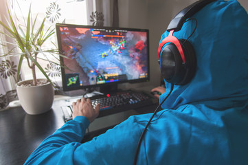 Back view of man playing PC game