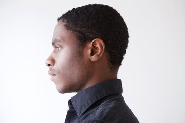 Profile young african man against white background