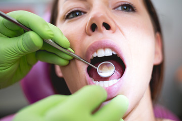 Dentist check up and repair tooth of young girl