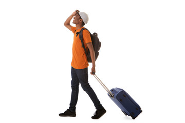 Full length happy african american male traveler walking with suitcase against isolated white...