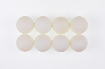 white abstract balls, eggs, geometric shapes, white background