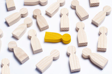 Wooden figures of people on a white background. The concept of society, collective, company, family, neighbors. A crowd of people at a meeting, rally. Workers, employees, citizens. Kids toys. Close up