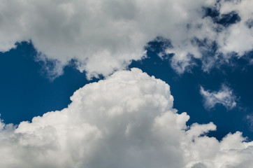Naklejka na ściany i meble Beautiful fluffy clouds against the blue sky