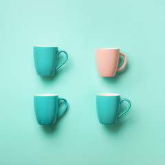 Pattern from blue cups over blue background. Square crop. Birthday party celebration, baby shower concept. Punchy pastel colors. Minimalist style design