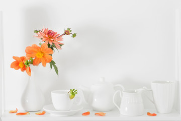 white dishvare with flowers on wooden shelf