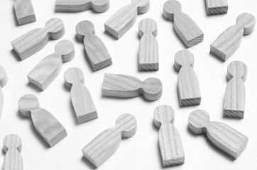 Wooden figures of people on a white background. The concept of society, collective, company, family, neighbors. A crowd of people at a meeting, rally. Workers, employees, citizens. Kids toys. Close up