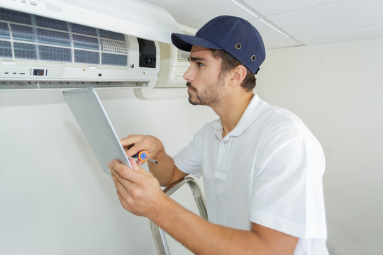 Young Contractor Working Carefully And Seriously At Clients Office