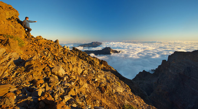 Resting man showing to a landscape above the crater Caldera de Taburiente, Island of La Palma, Canary Islands, Spain
