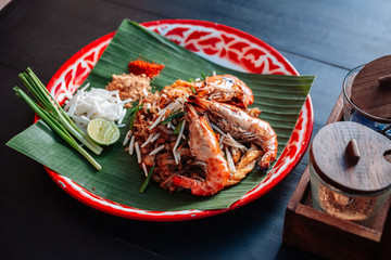 Prawn or Shrimp Pad Thai served with lime, scallions, bean sprouts. crushed peanut and chili powder.