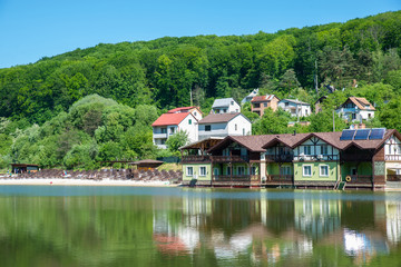 Fototapeta na wymiar cottage on river side in sunny day with sand beach.