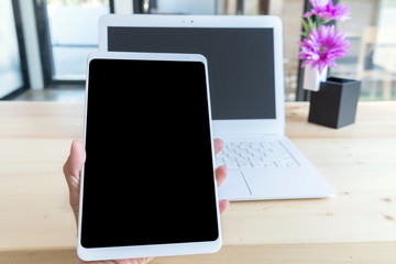 closeup tablet on blurred background office desk workplace white laptop with flower on wood table in modern office