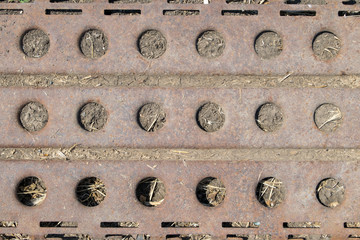Iron texture with holes, background of old iron products in the ground