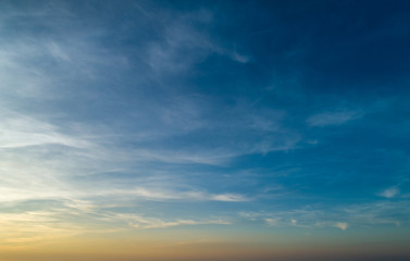 Beautiful sunset sky with clouds and orange strip along the horizon.