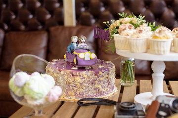 Wedding cake, the couple in the car, with topper LOVE, closeup, Wedding cupcakes