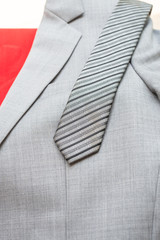 necktie and suit on red suitcase, business travel concept.