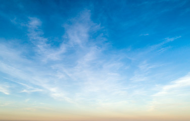 Beautiful sunset sky with clouds and orange strip along the horizon.