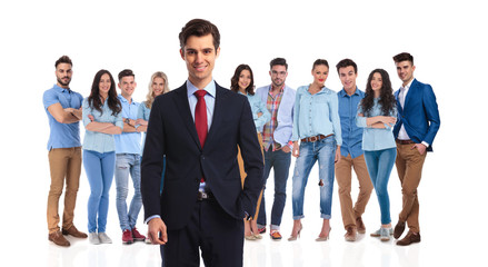 Fototapeta premium smiling team leader standing with his casual team behind