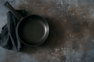 Empty iron pan on dark grunge background