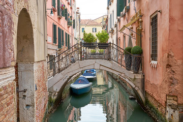 Typical small canal in Venice with nice bridges and boats