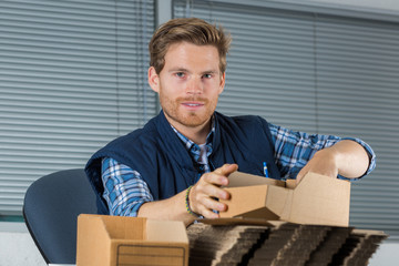 a man holds envelopes in office