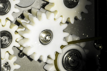 white gears background, linking mechanism close-up photo