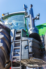 Tractor for farm work, modern agricultural transport working in the field, modern tractor close-up