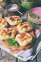 Mini pies made of puff pastry, custard and caramelized rhubarb. Homemade baking. Delicious freshly baked cookies. Rustic photo